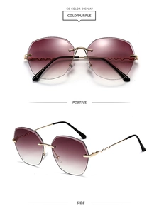 Detail of gold wavy metal temples and purple gradient lenses on oversized sunglasses