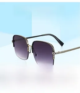 Detail of gold metal frame sunglasses with purple gradient lenses and geometric patterns