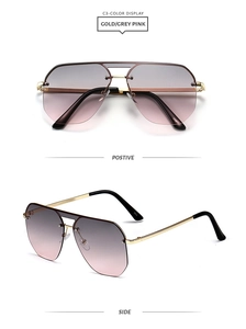 Detail of trendy rimless sunglasses with gold metal bridge and grey pink gradient lenses