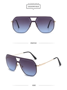 Détail de lunettes de soleil en métal doré avec verres dégradés violet bleu et double pont