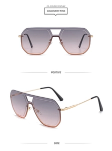Détail de lunettes de soleil dorées à double pont avec verres dégradés gris-rose et branches