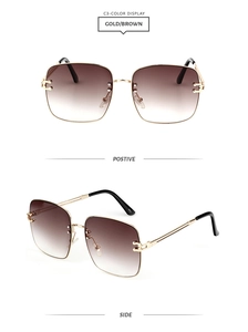 Close-up of oversized square sunglasses with gold metal frame and gradient brown lenses