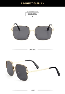 Detail view of gold metal square sunglasses with grey lenses and geometric texture