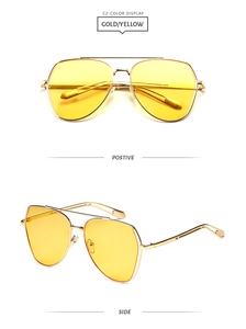 Detail view showing gold metal aviator sunglasses with yellow lenses and double bridge
