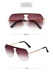 Close-up of double-bridge aviator sunglasses with gold frame and purple gradient lenses