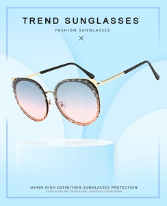 Detailed view of cat-ear gold frame sunglasses with blue-pink gradient UV400 lenses