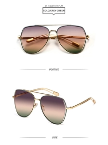 Close-up of gold double-bridge aviator sunglasses with purple-to-green gradient lenses