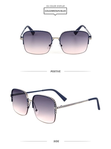Macro view of gold metal frame sunglasses with blue-purple gradient lenses and engravings