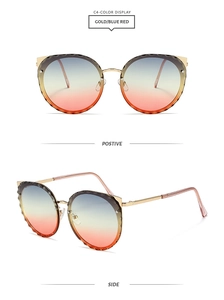Detail of cat-eye gold frame sunglasses with gradient lenses and scalloped cut edges