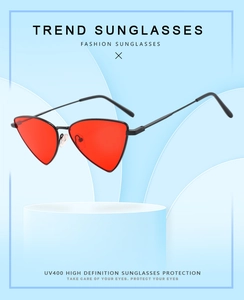 Detail of red triangular sunglasses with black metal frame and UV400 protection lens