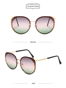 Detail of cat-ear gold frame sunglasses with gradient pink lenses and diamond-cut edges