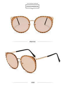 Detail of champagne rimless lenses with faceted edges and gold metal cat-ear frames