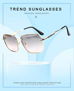 Detail of square gold metal sunglasses with gradient purple lenses on a blue stand