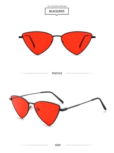 Detail of triangle cat-eye sunglasses with thin black metal frame and red lenses