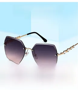 Detail view of purple gradient frameless lens with rhinestone-studded gold metal temples