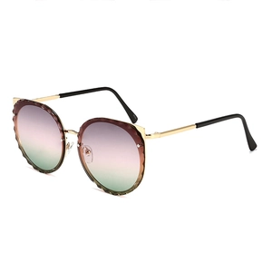 Cat ear gold frame sunglasses with gradient lenses and textured wavy edges for women