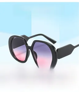Macro shot of stylish oversized sunglasses featuring thick black frames and purple gradient lenses