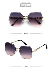 Detail view of gold metal temples with wave texture and rhinestones on purple sunglasses