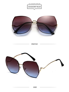 Detail of oversized rimless sunglasses featuring gradient lenses and gold wavy temples