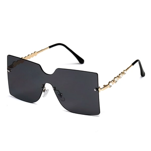 Oversized rimless shield sunglasses with dark grey lenses and gold rhinestone temples
