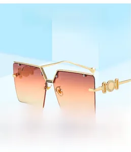 Detail of square gradient lenses and decorative gold chain metal temples on sunglasses