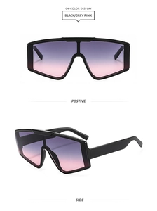 Detail of square oversized shield sunglasses in black frame with grey-pink gradient lenses