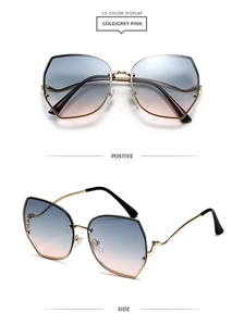 Detail view of gold metal sunglasses with curved temples and grey-pink gradient lenses
