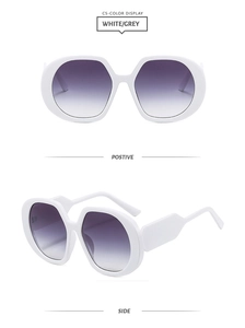 Detail view of white oversized hexagonal sunglasses with gradient lenses in two angles