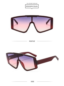 Detail of translucent burgundy oversized sunglasses with purple and yellow gradient lenses