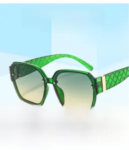 Detail of square emerald green sunglasses featuring woven textured temples and gold accents