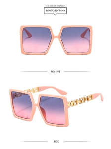 Detail of pink square frame sunglasses with gold Greek key pattern on the temple