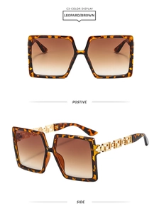 Detail of leopard print square sunglasses with golden Greek key hollow temple design