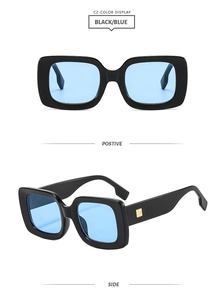 Detail view of bold black square frame sunglasses with blue lenses and gold metal accents
