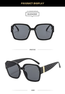 Detail showing classic black square frame sunglasses with quilted texture and gold metal accents