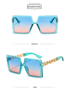 Detail of square sunglasses with Greek fret gold metal temples and blue pink gradient lens