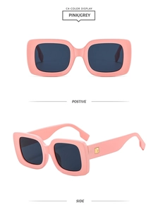 Detail view of pink square frame sunglasses with grey lenses and gold metal hinges