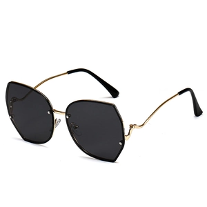 Irregular polygonal gold metal sunglasses with curved temples and dark grey lenses