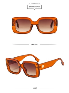 Detail of square brown gradient sunglasses with golden metal hinge ornaments