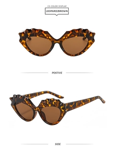 Detail view of leopard print cat eye sunglasses with brown lenses and jagged frames