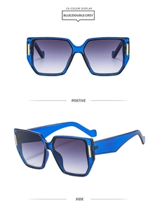 Detail view of square blue acetate sunglasses with grey gradient lenses and gold metal accents