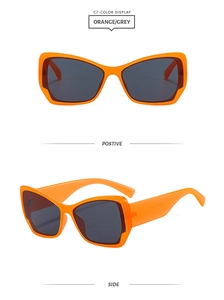 Détail macro de lunettes de soleil œil-de-chat orange vif avec verres gris foncés