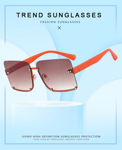Detail view of orange semi-rimless square sunglasses with UV400 gradient brown lenses