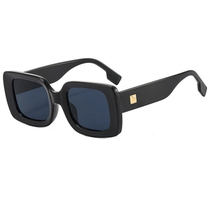 Classic square black sunglasses with gold metal studs and dark lenses on white background