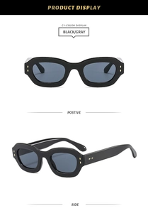 Detail view of retro black frame sunglasses with dark gray lenses and golden double rivets