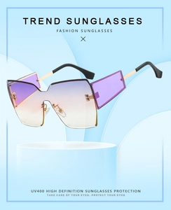 Detail of oversized rimless sunglasses featuring UV400 gradient lenses and metal temples