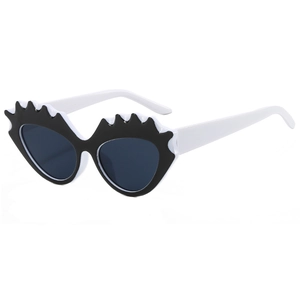Retro cat eye sunglasses with black and white jagged frame and grey lenses for street style