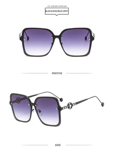 Detail view of square black sunglasses with gradient lenses and metal temple accents
