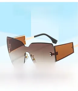Detail of oversized rimless sunglasses with gradient brown lenses and silver metal rivets