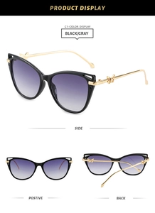 Black cat-eye sunglasses with purple gradient lenses and gold butterfly temple detail