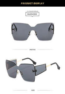 Detail view showing front and side profile of rimless oversized sunglasses with gold rivets
